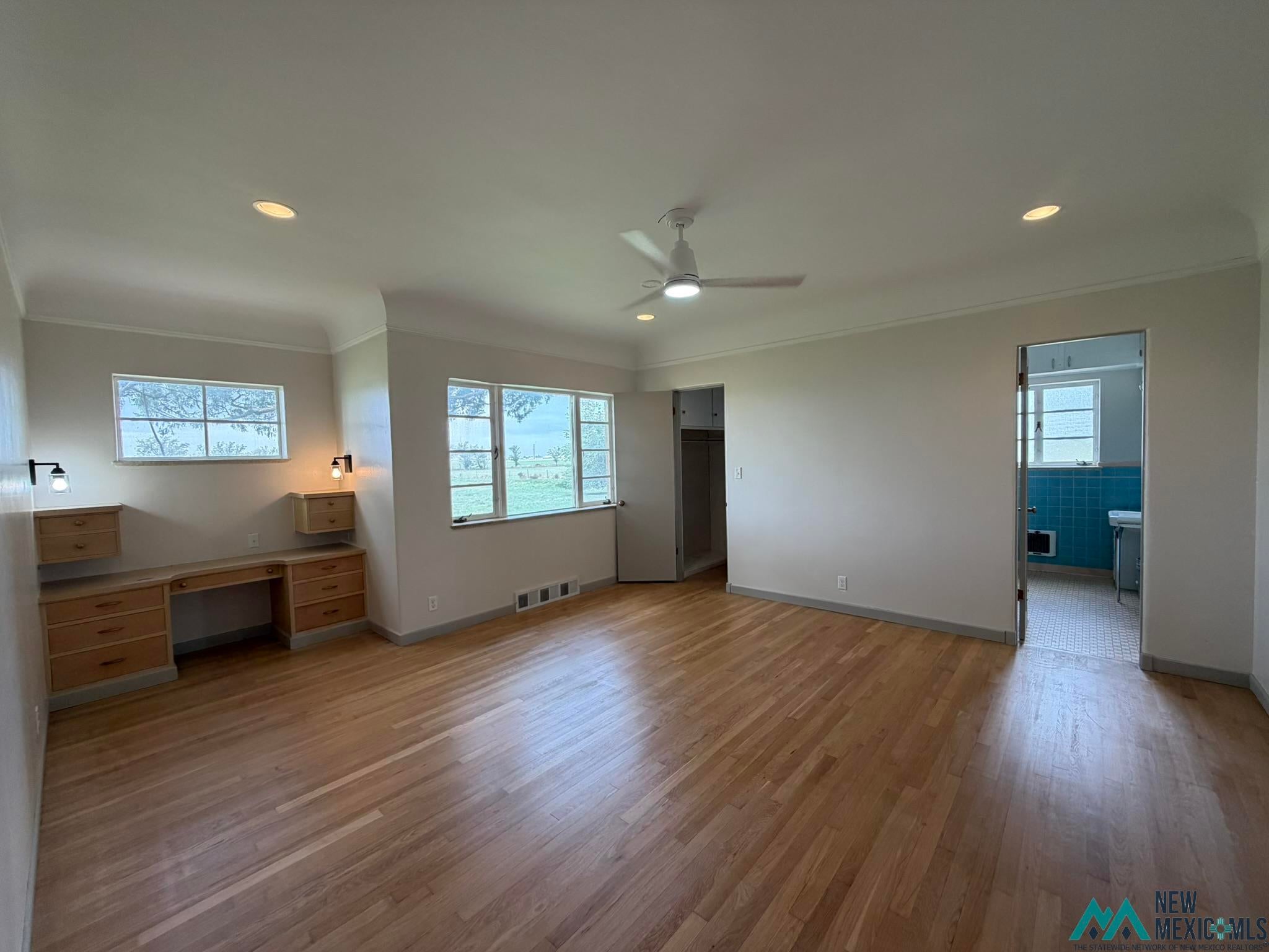 570 Curry Road North Clovis, NM 88101 - Photo 27 of 59 Spacious room featuring wood-finish flooring, recessed lighting, and a ceiling fan