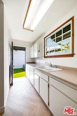 a bathroom with a granite countertop sink and a large mirror