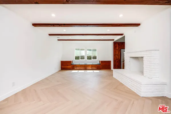 a view of an empty room with a fireplace