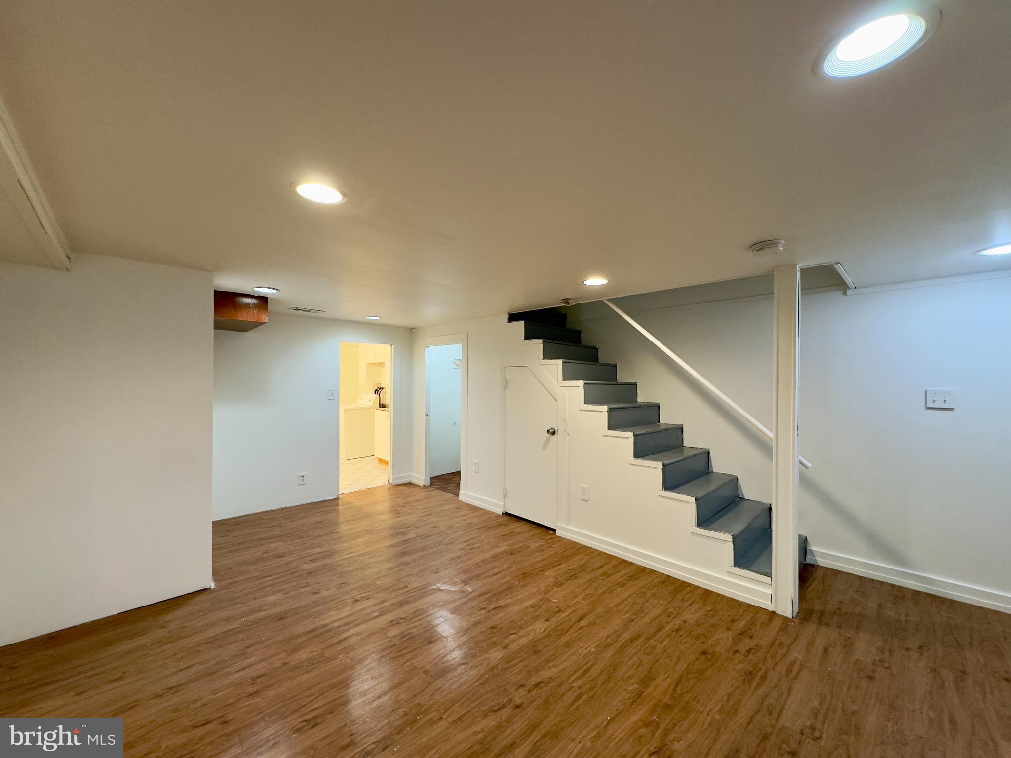 512 Umbra Street Baltimore, MD 21224 - Photo 16 of 20 a view of an empty room with wooden floor and stairs