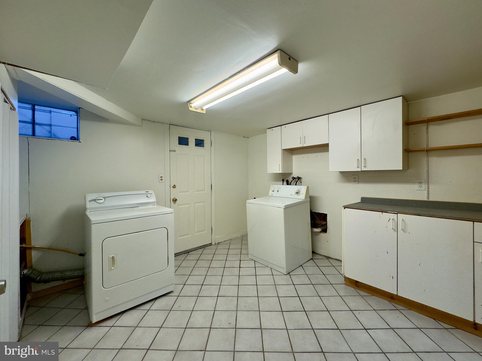 512 Umbra Street Baltimore, MD 21224 - Photo 18 of 20 a utility room with cabinets washer and dryer