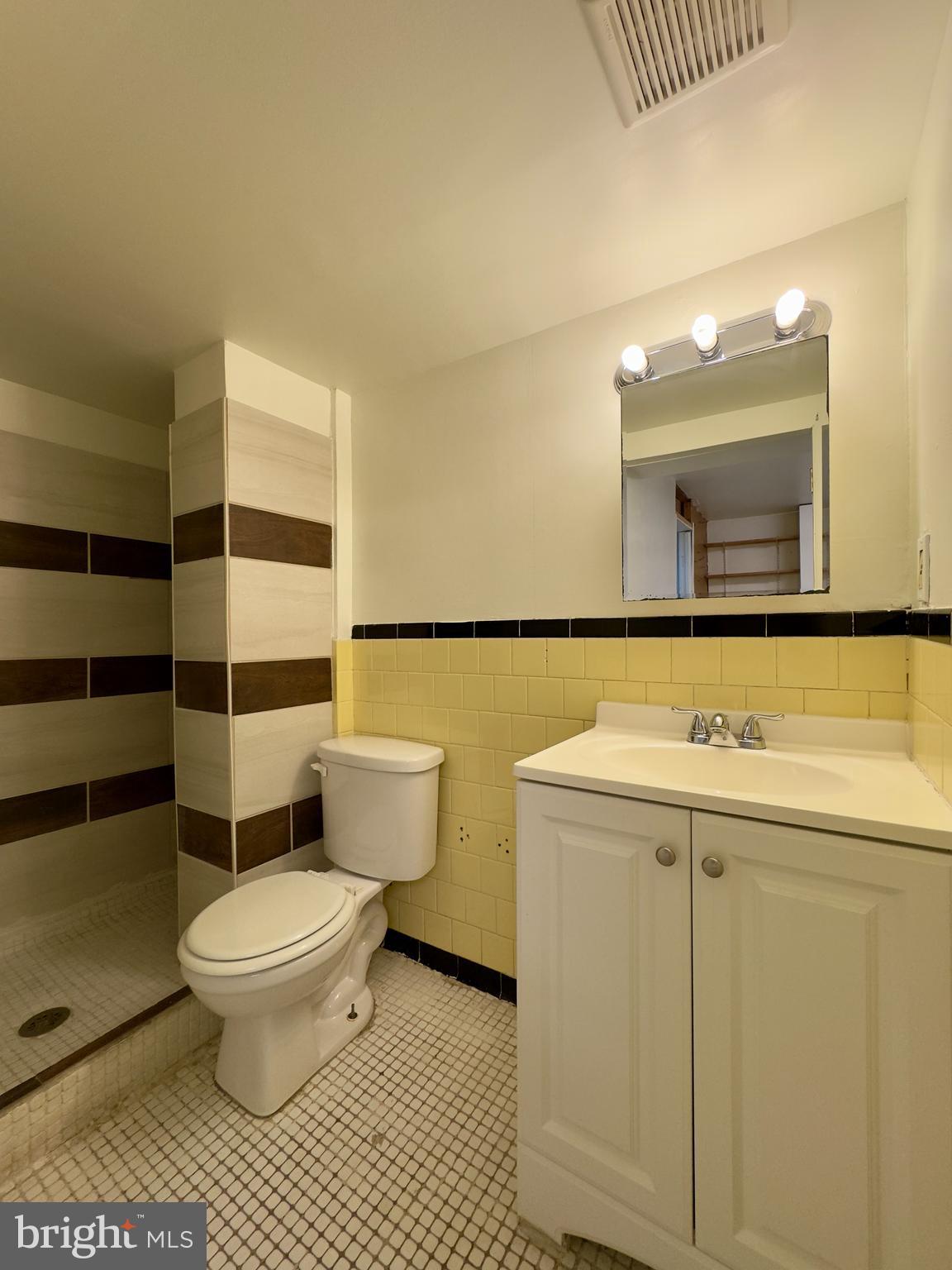 512 Umbra Street Baltimore, MD 21224 - Photo 20 of 20 a bathroom with a sink a toilet and a mirror