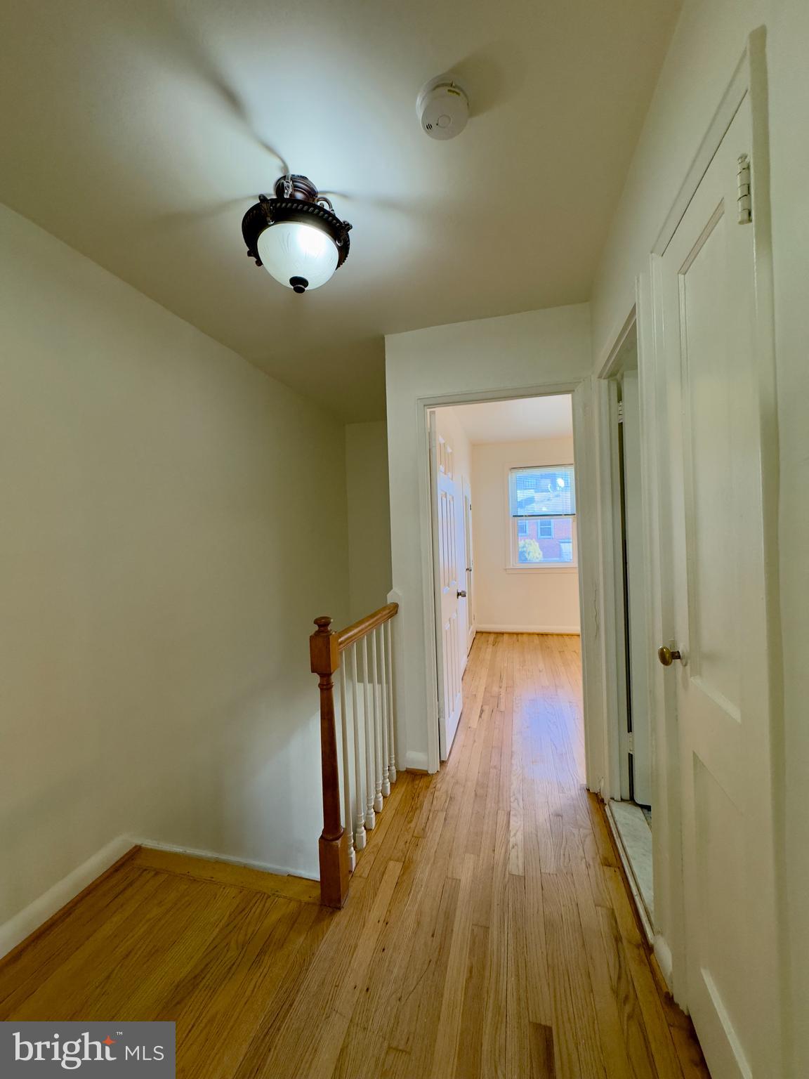 512 Umbra Street Baltimore, MD 21224 - Photo 7 of 20 a view of a hallway with wooden floor
