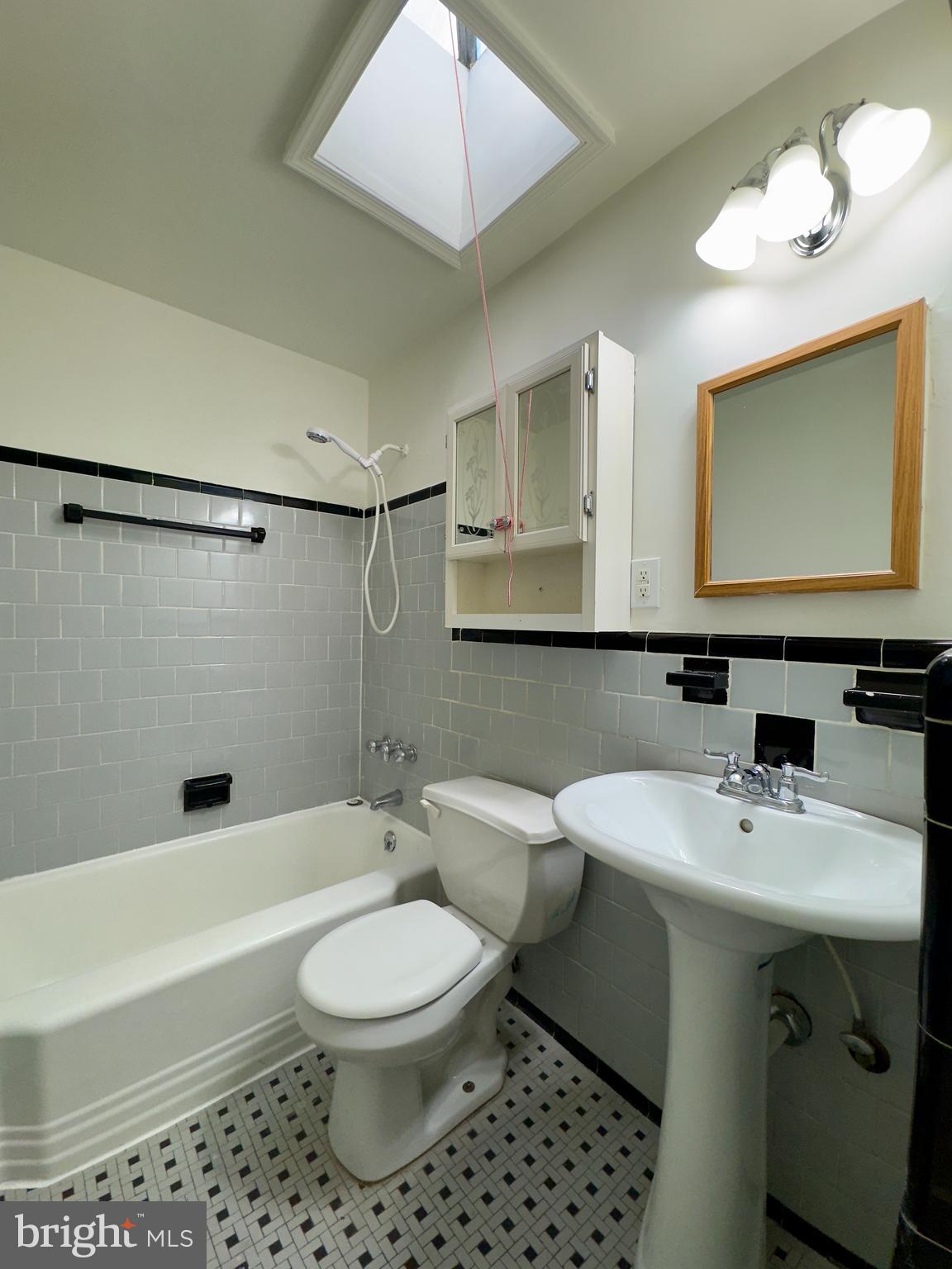 512 Umbra Street Baltimore, MD 21224 - Photo 9 of 20 a bathroom with a sink toilet and shower
