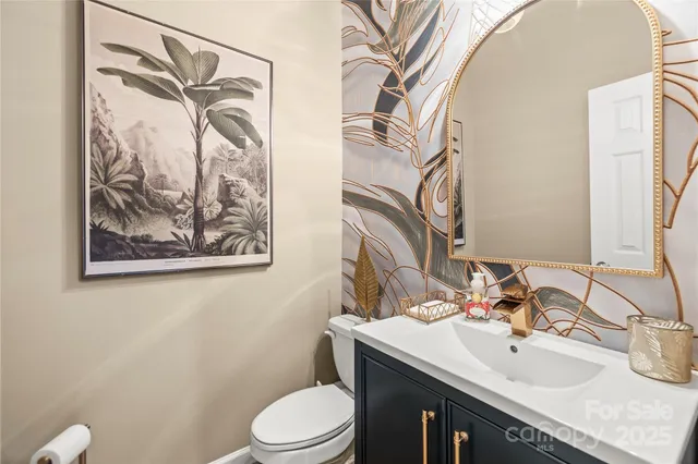 a living room with furniture a flat screen tv and a chandelier