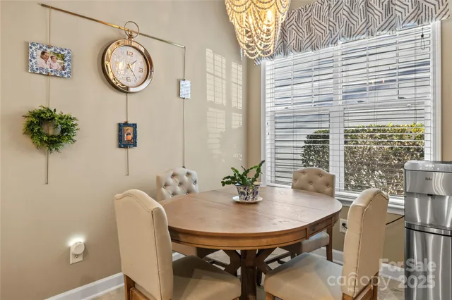 a utility room with stainless steel appliances kitchen island granite countertop a sink and a flat screen tv