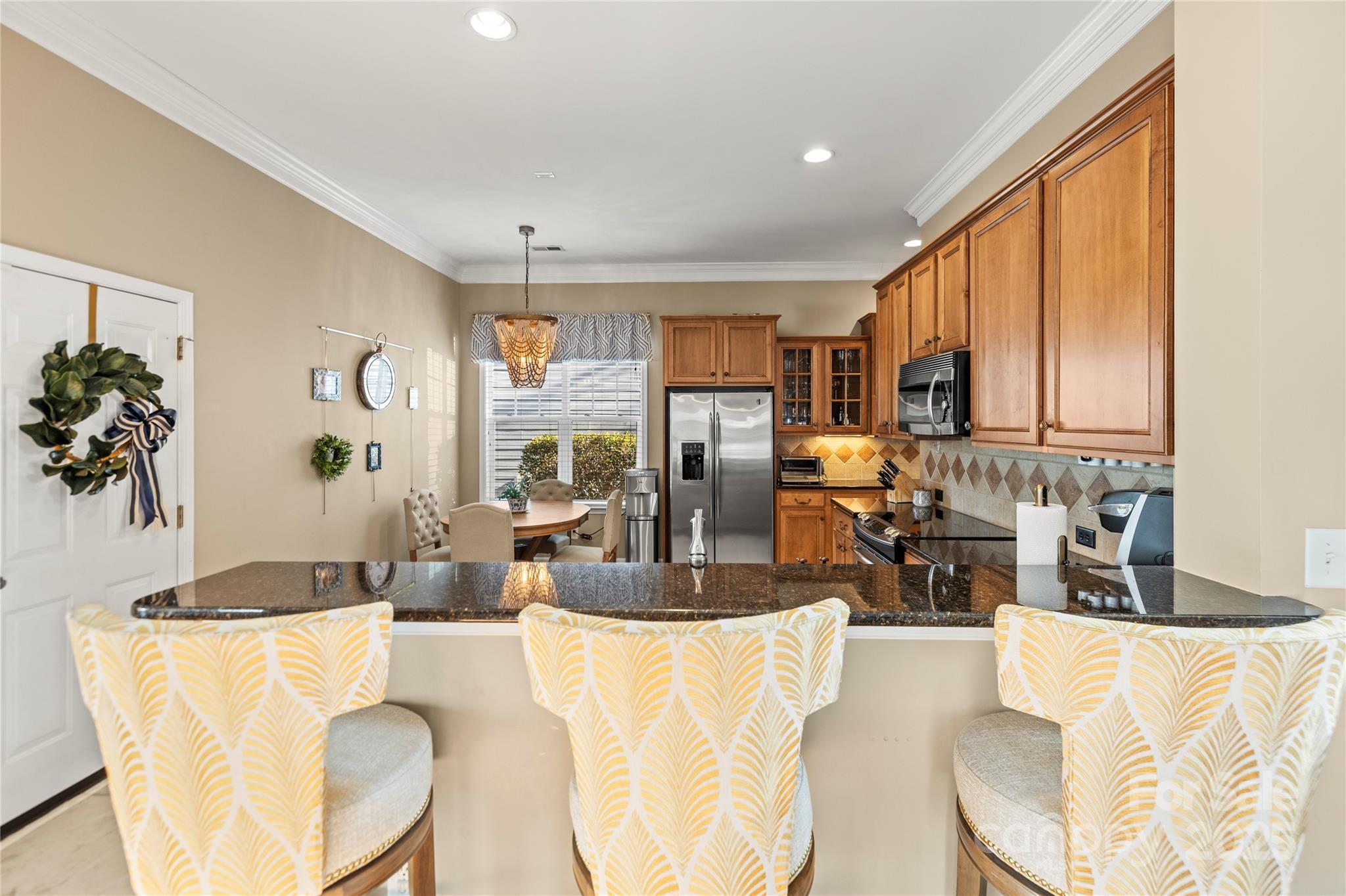 9415 Rosalyn Glen Road Cornelius, NC 28031 - Photo 27 of 46 a living room with kitchen island furniture and a large window