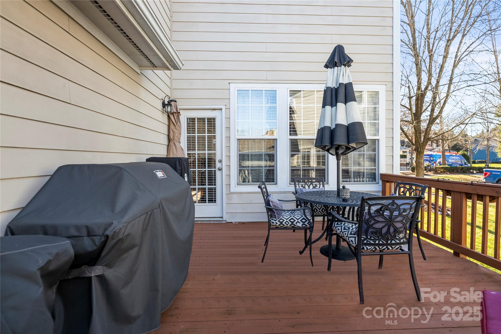 9415 Rosalyn Glen Road Cornelius, NC 28031 - Photo 45 of 46 a view of a patio with table and chairs and wooden floor