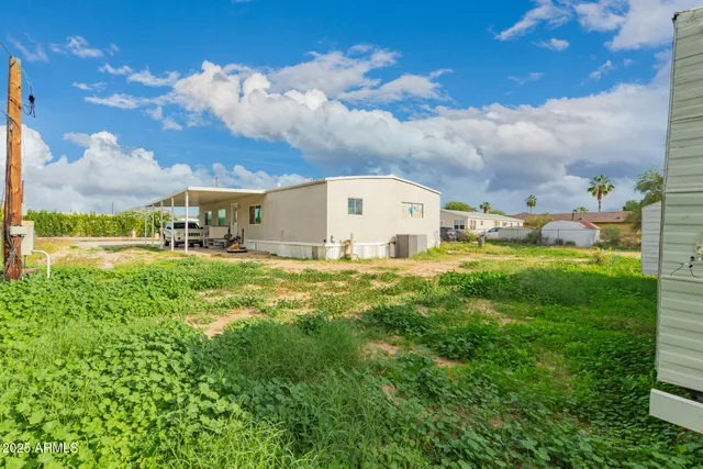 a view of a big yard with table and chairs