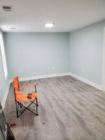 a view of a room with chair and wooden floor