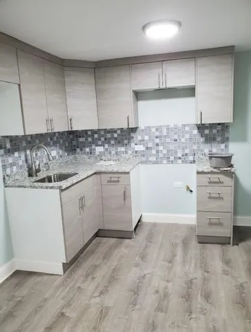 a kitchen with a stove a sink and a refrigerator