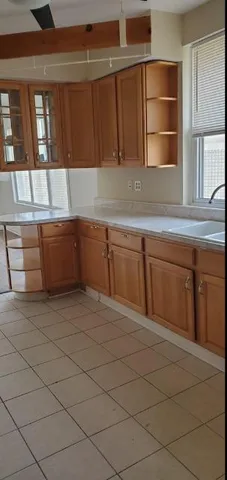a kitchen with granite countertop a sink and cabinets