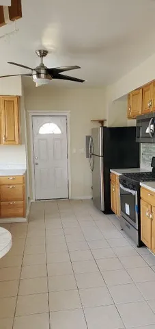 a view of a kitchen with microwave and cabinets