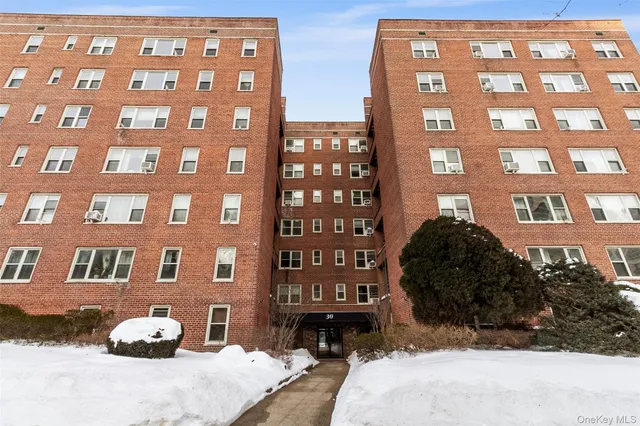 a front view of a residential apartment building with a yard