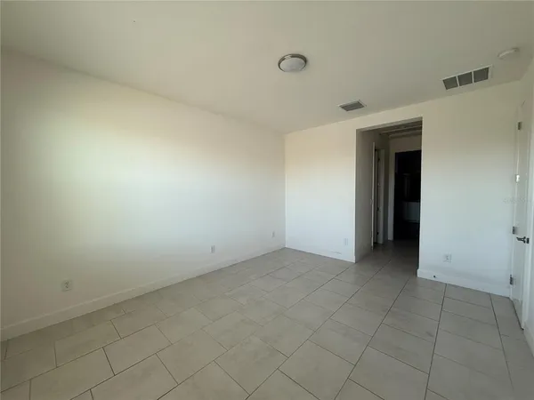 an empty room with white walls and cabinet