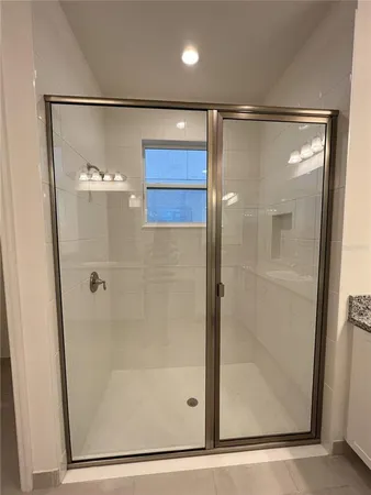 a bathroom with a glass shower door