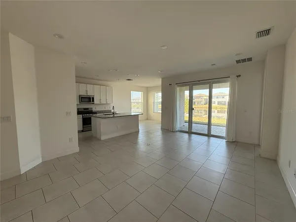 a view of a kitchen with a sink and a stove top oven