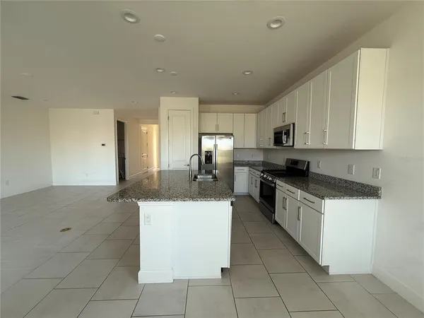 a kitchen with stainless steel appliances granite countertop a sink and a stove