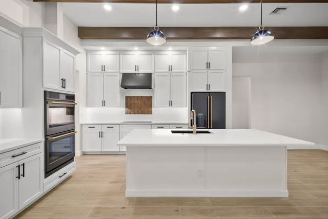 a kitchen with stainless steel appliances granite countertop a stove and a sink