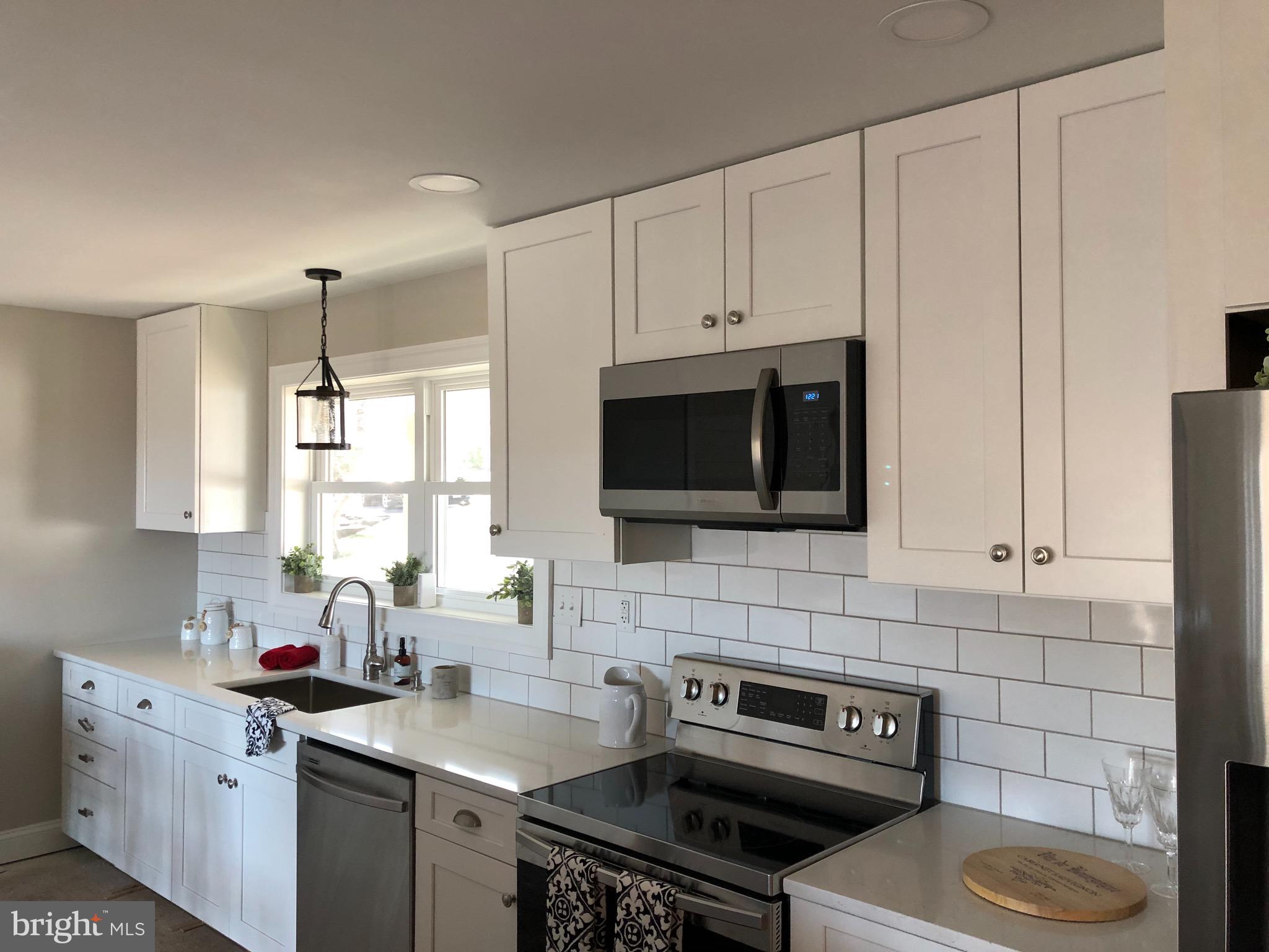 138 Grimes Golden Road Linden, VA 22642 - Photo 27 of 77 a kitchen with a sink stove and microwave