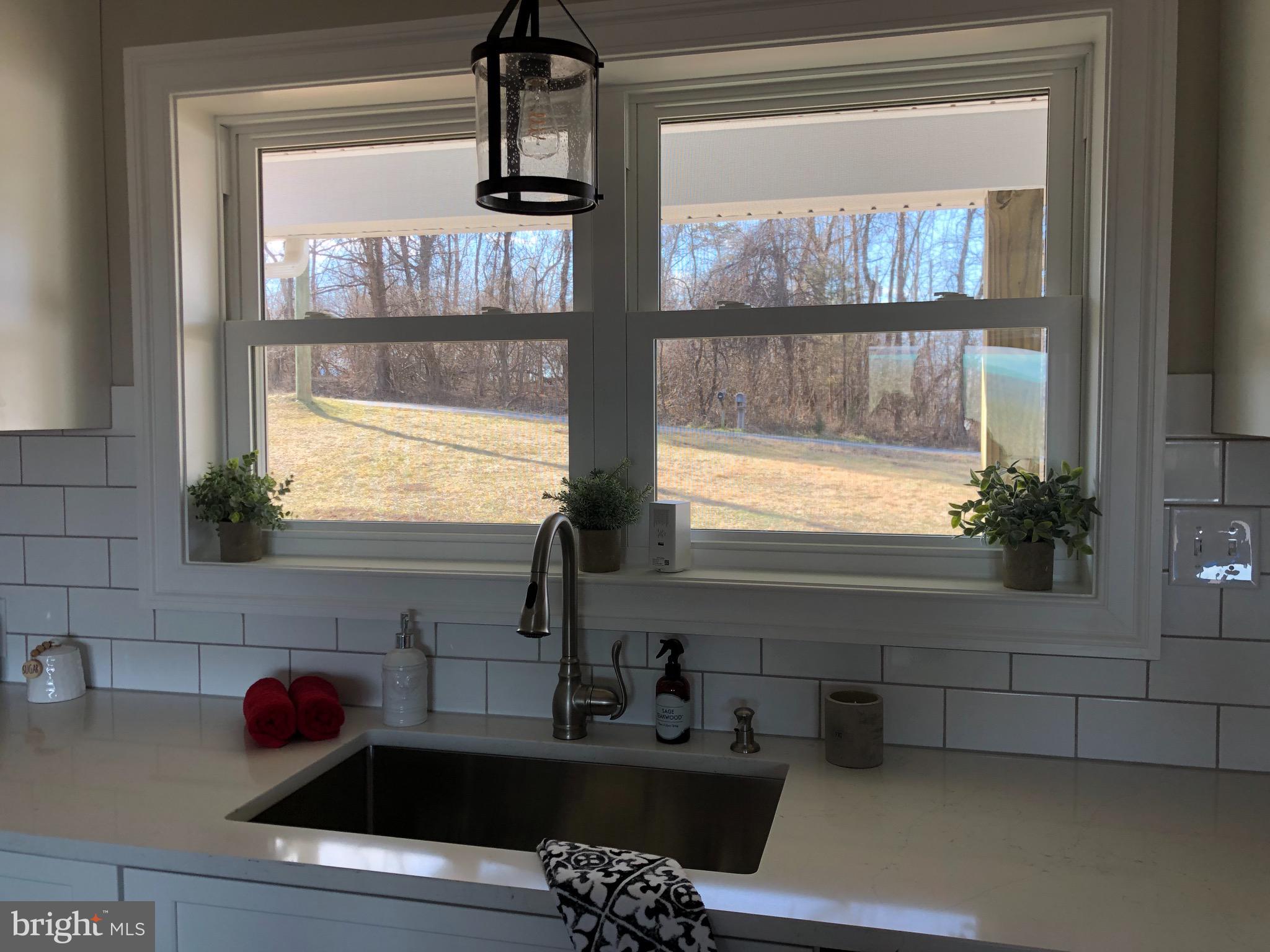 138 Grimes Golden Road Linden, VA 22642 - Photo 30 of 77 a kitchen with a sink a window and cabinets