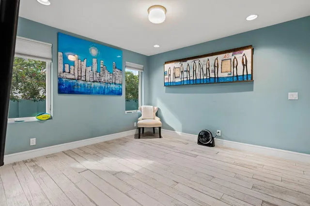 a bathroom with a granite countertop toilet a sink and a mirror