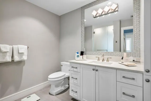 a spacious bathroom with a toilet a sink and a window