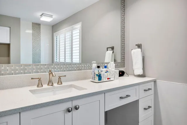 a spacious bedroom with a bed and a flat screen tv