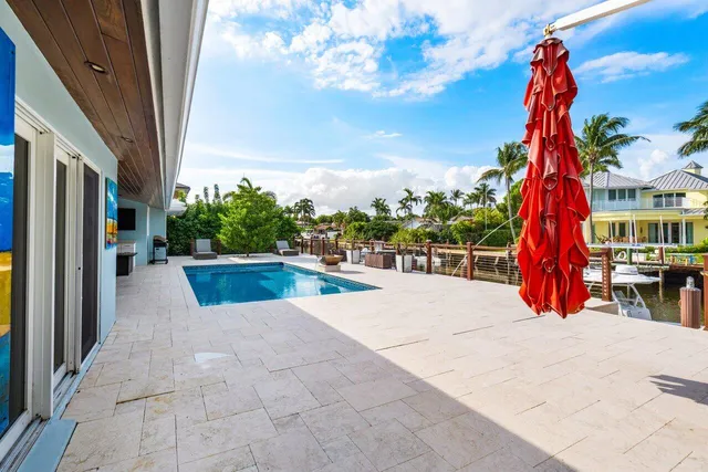 a view of a house with swimming pool and porch with furniture