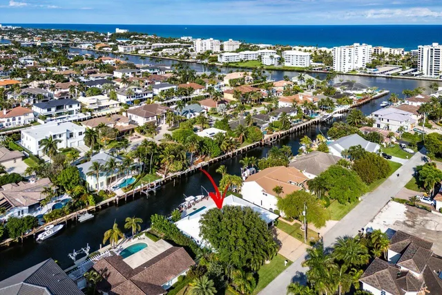 an aerial view of a house with swimming pool and patio