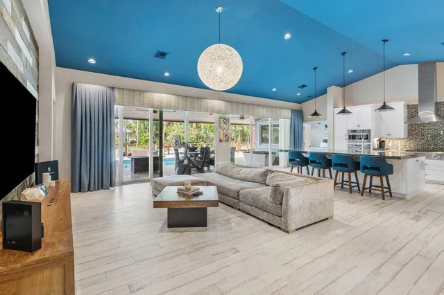 a living room with furniture and kitchen view