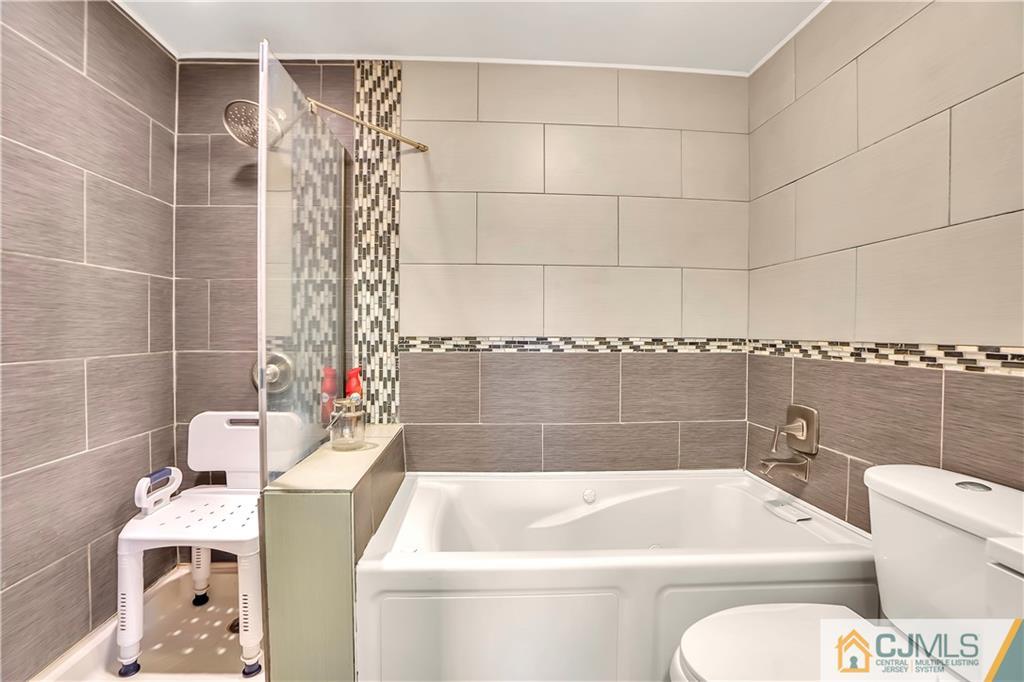 141 Old Road Sewaren, NJ 07077 - Photo 11 of 30 a bathroom with a sink and bathtub
