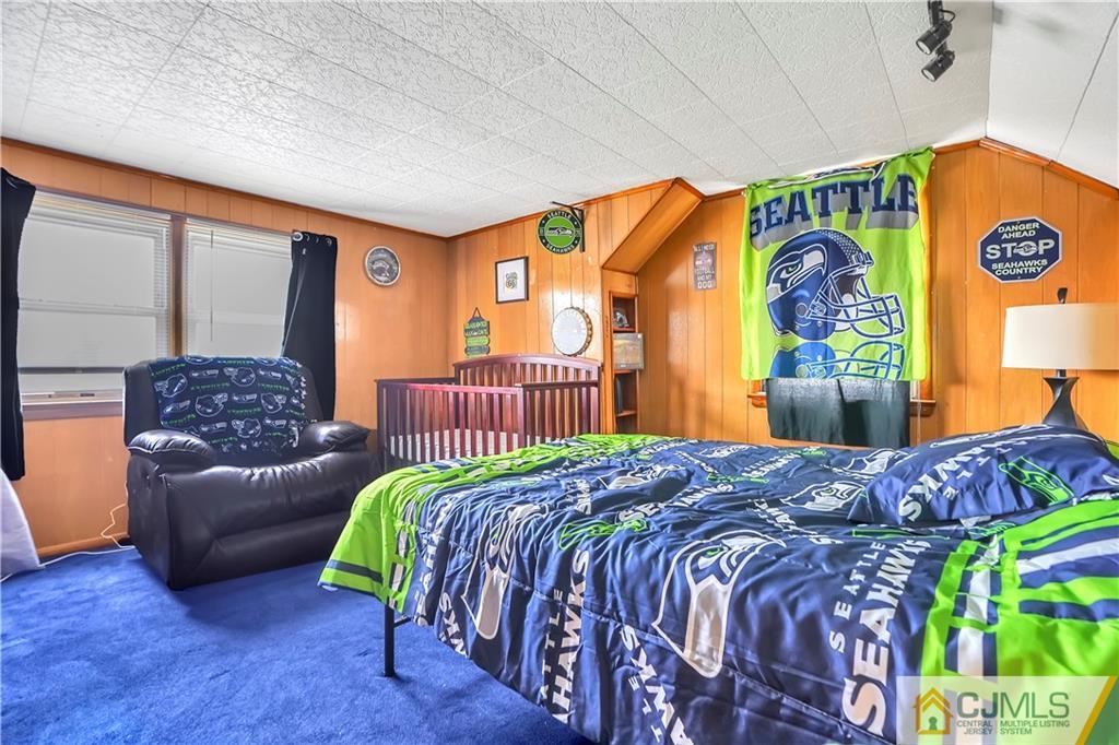 141 Old Road Sewaren, NJ 07077 - Photo 12 of 30 a bedroom with a bed and a couch