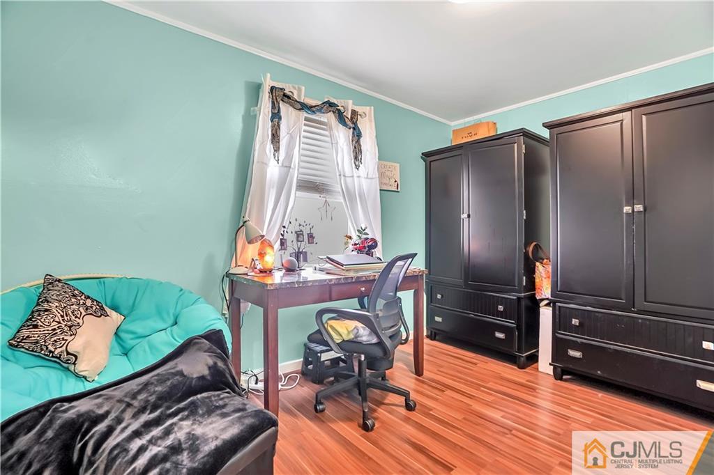 141 Old Road Sewaren, NJ 07077 - Photo 16 of 30 a bedroom with furniture and a window