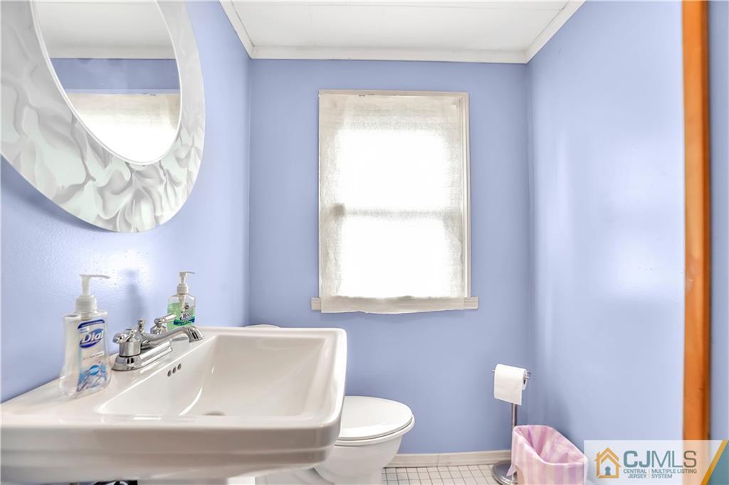 141 Old Road Sewaren, NJ 07077 - Photo 17 of 30 a bathroom with a sink and a mirror