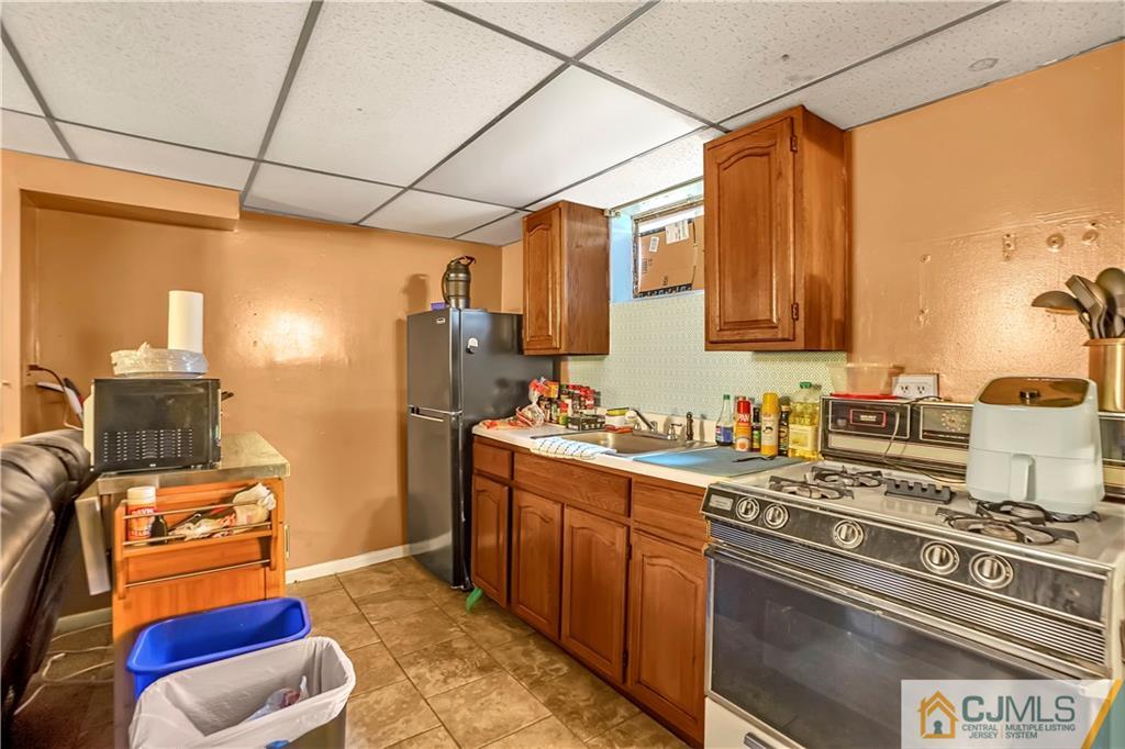 141 Old Road Sewaren, NJ 07077 - Photo 19 of 30 a kitchen with stainless steel appliances granite countertop a stove a sink and a refrigerator