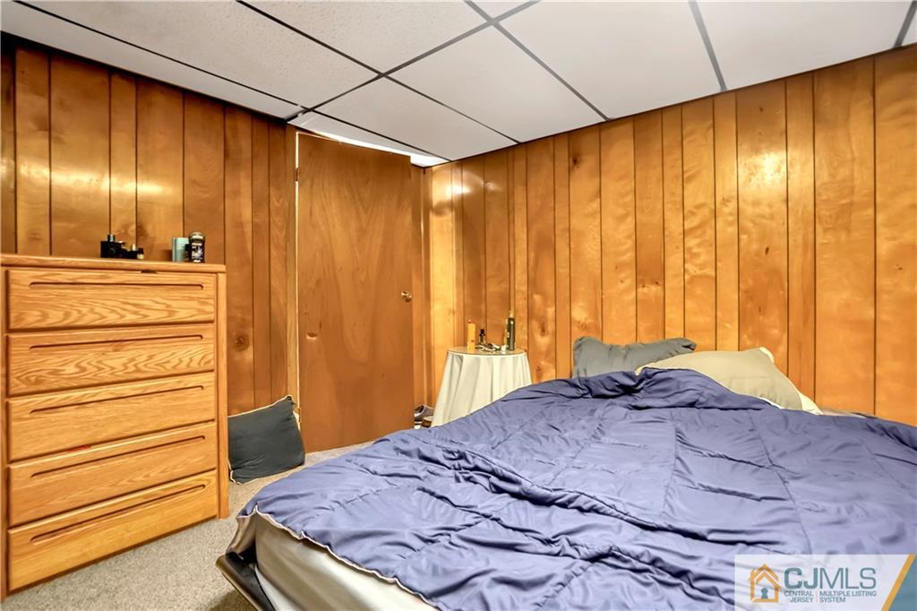 141 Old Road Sewaren, NJ 07077 - Photo 22 of 30 a bedroom with a bed and a dresser