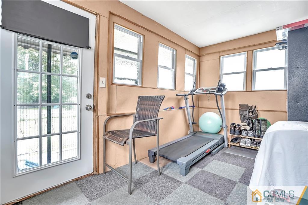 141 Old Road Sewaren, NJ 07077 - Photo 23 of 30 a living room with furniture a dining table and a large window