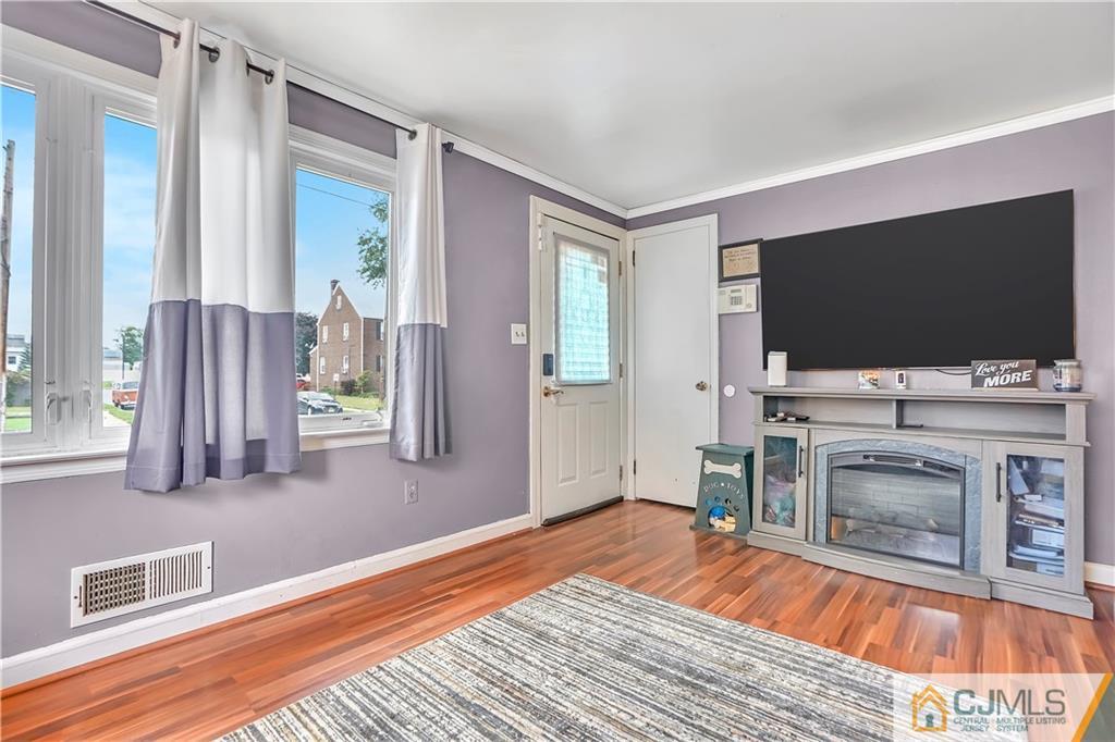 141 Old Road Sewaren, NJ 07077 - Photo 3 of 30 a bedroom with furniture and a flat screen tv