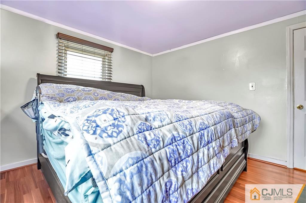 141 Old Road Sewaren, NJ 07077 - Photo 9 of 30 a bedroom with a bed and a window