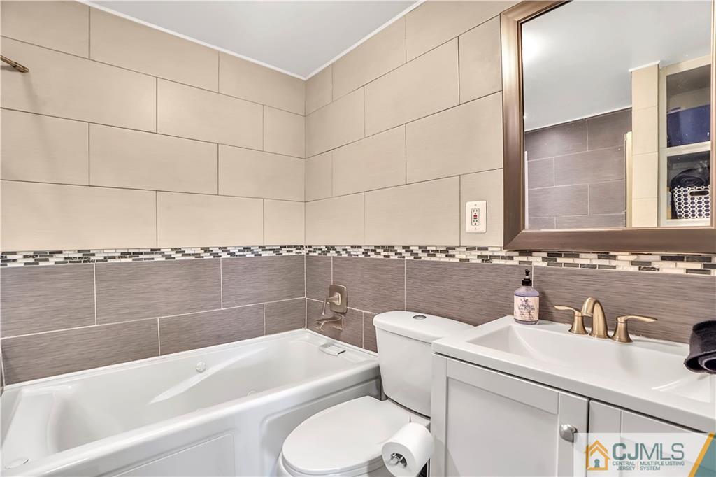 141 Old Road Sewaren, NJ 07077 - Photo 10 of 30 a bathroom with a sink a toilet and bathtub