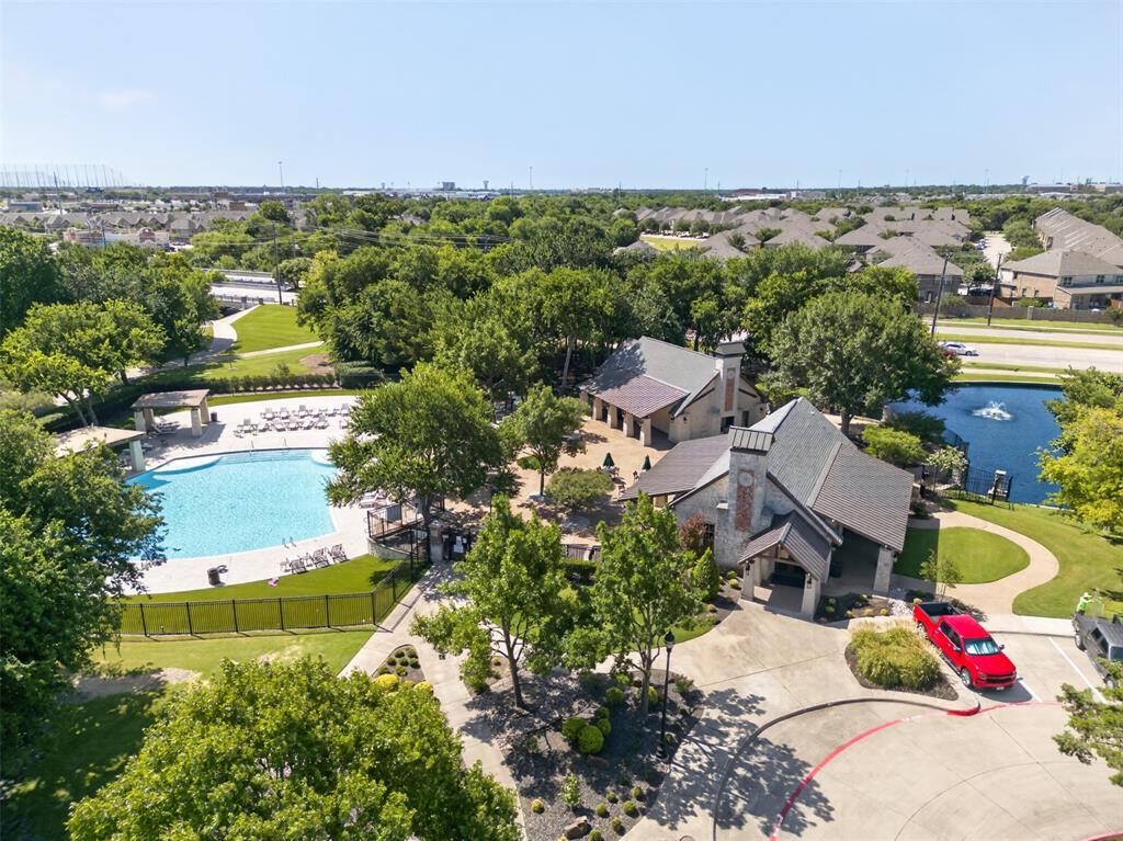 842 Sun Meadow Road Allen, TX 75013 - Photo 39 of 39 Community amenities featuring a large swimming pool, a stone-clad clubhouse, and a decorative pond with a fountain
