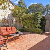 a backyard of a house with barbeque oven and outdoor seating