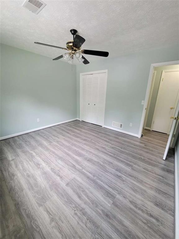 4648 Pine Tree Circle, Unit B Buford, GA 30518 - Photo 15 of 19 wooden floor in an empty room