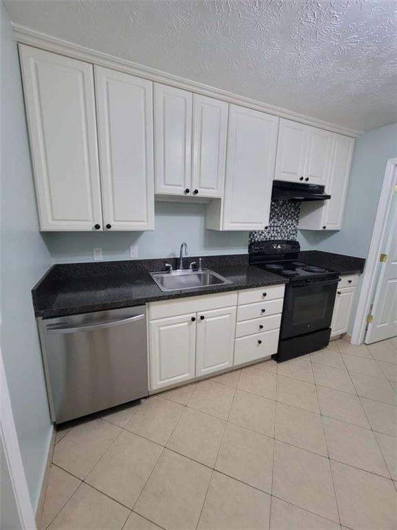 4648 Pine Tree Circle, Unit B Buford, GA 30518 - Photo 17 of 19 a kitchen with granite countertop white cabinets and stainless steel appliances