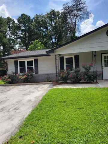 a front view of house with yard and green space