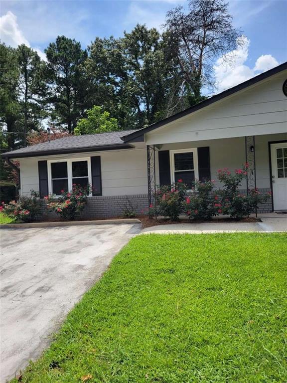 4648 Pine Tree Circle, Unit B Buford, GA 30518 - Photo 2 of 19 a front view of house with yard and green space