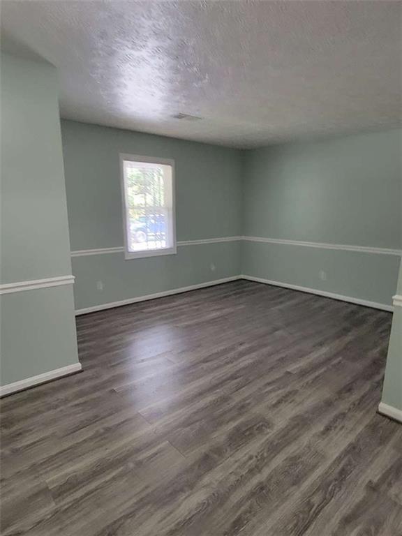 4648 Pine Tree Circle, Unit B Buford, GA 30518 - Photo 6 of 19 wooden floor in an empty room with a window