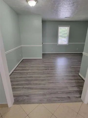 a view of room with window and hardwood floor