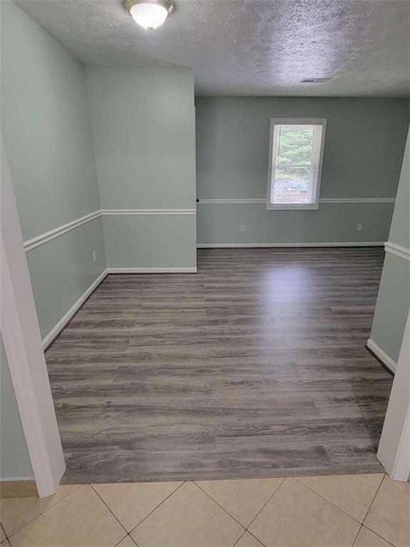 4648 Pine Tree Circle, Unit B Buford, GA 30518 - Photo 7 of 19 a view of room with window and hardwood floor
